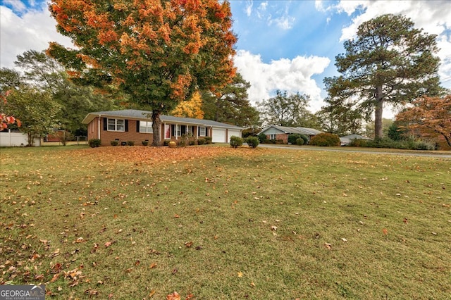 ranch-style home with a garage and a front lawn