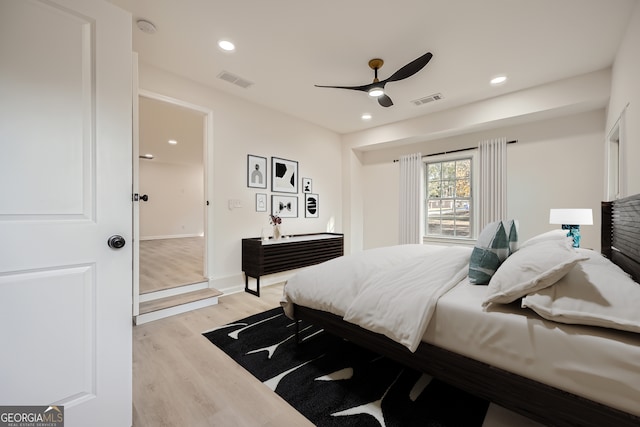 bedroom with light hardwood / wood-style floors and ceiling fan