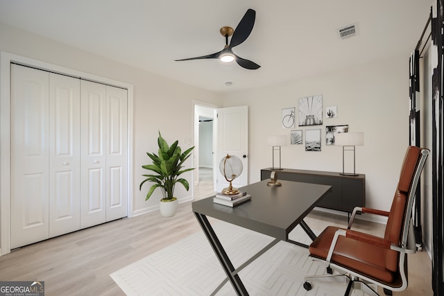 office space featuring ceiling fan and light hardwood / wood-style flooring