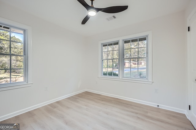 spare room with light hardwood / wood-style flooring and ceiling fan