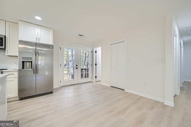 kitchen featuring french doors, white cabinets, stainless steel appliances, and light hardwood / wood-style flooring