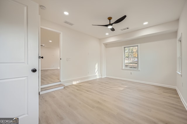 empty room featuring ceiling fan and light hardwood / wood-style flooring