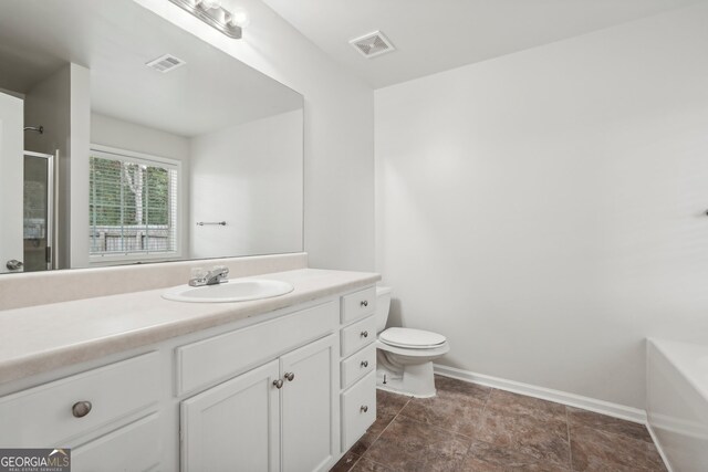 bathroom featuring vanity and toilet