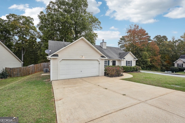 view of front facade with cooling unit, a garage, and a front lawn