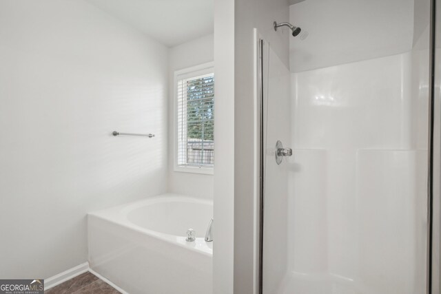 bathroom with tile patterned floors and shower with separate bathtub