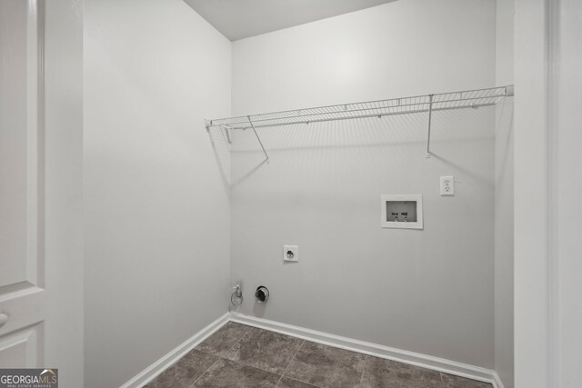 laundry room with hookup for a gas dryer, hookup for a washing machine, dark tile patterned flooring, and hookup for an electric dryer