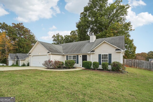 ranch-style house with a front yard and a garage