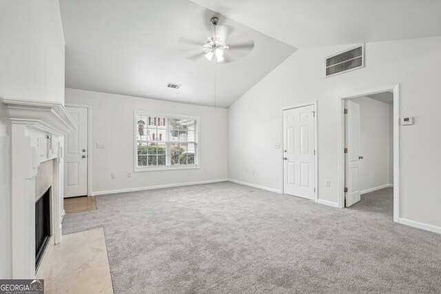 unfurnished living room with ceiling fan, high vaulted ceiling, and light colored carpet