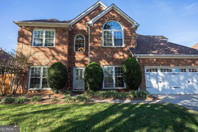 view of front property featuring a front yard and a garage