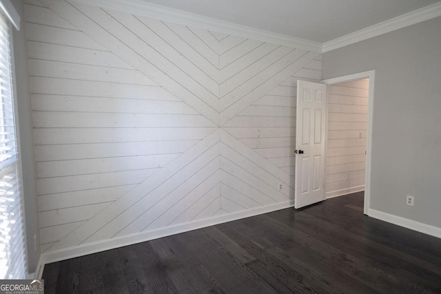 spare room with wooden walls, dark hardwood / wood-style flooring, and ornamental molding