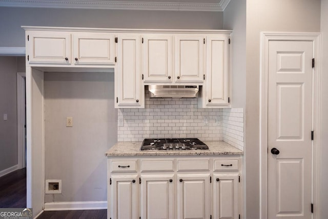 kitchen with white cabinets, extractor fan, and stainless steel gas cooktop