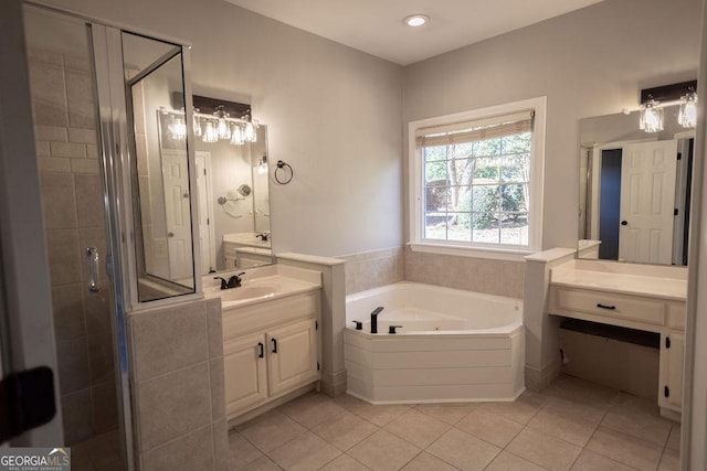 bathroom featuring tile patterned floors, vanity, and shower with separate bathtub