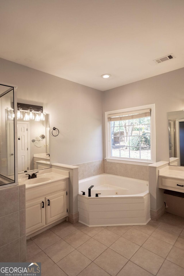 bathroom featuring a bath, vanity, and tile patterned floors