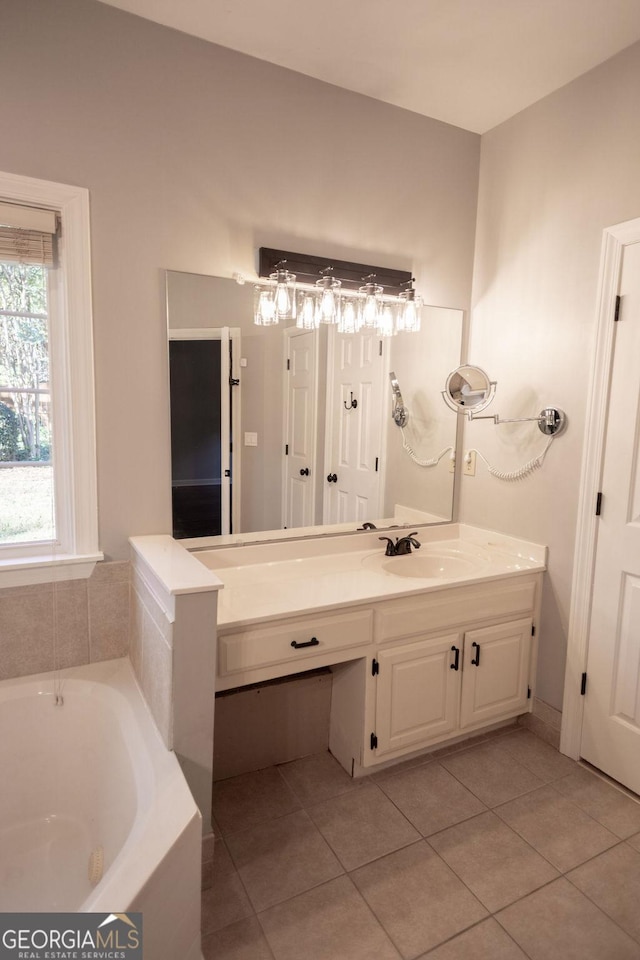 bathroom featuring tile patterned floors, a washtub, and vanity