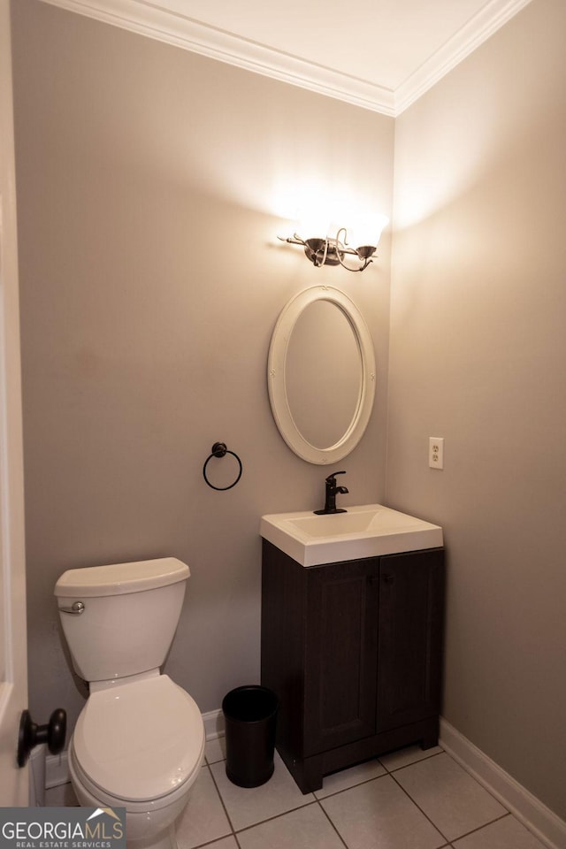 bathroom with toilet, tile patterned flooring, vanity, and ornamental molding