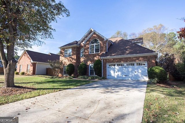 view of property featuring a garage and a front yard