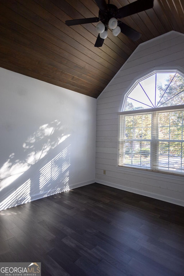 spare room featuring dark hardwood / wood-style floors, vaulted ceiling, and wood ceiling