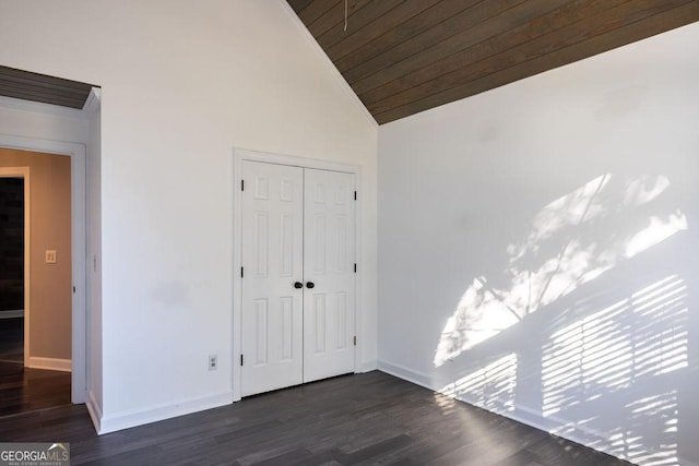 unfurnished bedroom with dark hardwood / wood-style flooring, wood ceiling, high vaulted ceiling, and a closet