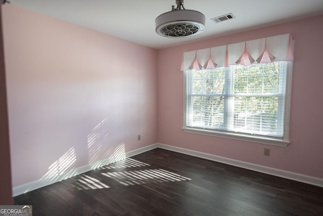 spare room with dark hardwood / wood-style flooring