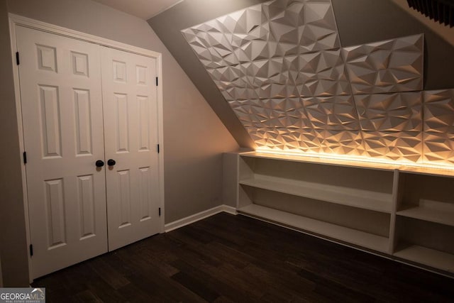 bonus room with dark hardwood / wood-style floors and lofted ceiling