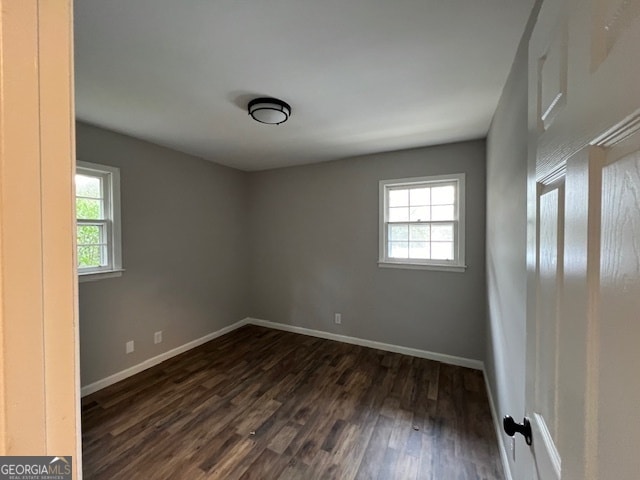 empty room with dark wood-type flooring