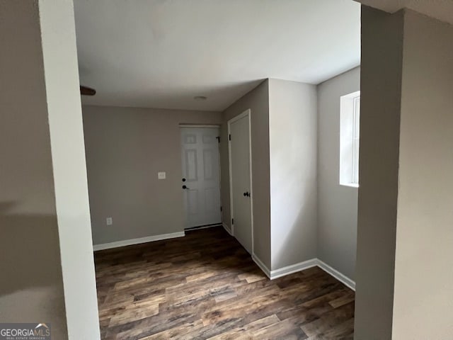 corridor featuring dark wood-type flooring