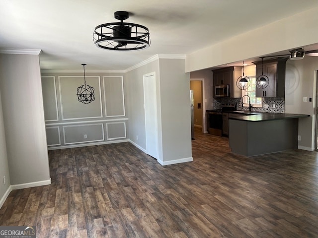 unfurnished dining area featuring dark hardwood / wood-style flooring, ornamental molding, and sink