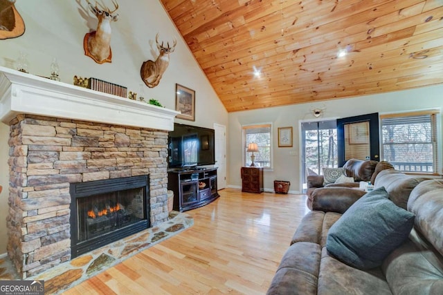 living room with light wood-type flooring, a fireplace, high vaulted ceiling, and wooden ceiling