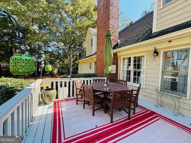 wooden deck with outdoor dining area