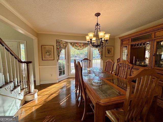 dining area with stairs, ornamental molding, a chandelier, and a textured ceiling