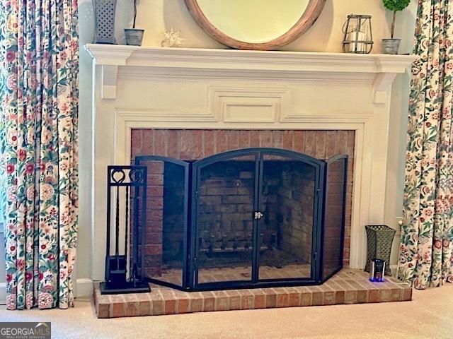 details featuring carpet floors and a fireplace