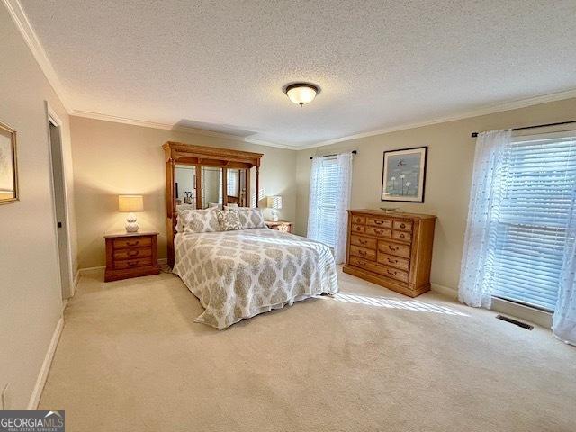 bedroom featuring light carpet, crown molding, visible vents, and baseboards