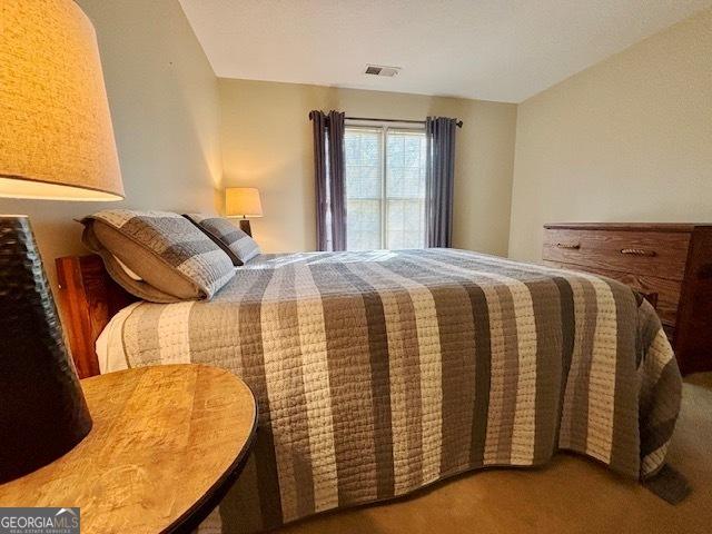 bedroom with carpet and visible vents