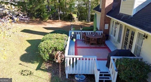 exterior space with a deck and outdoor dining space