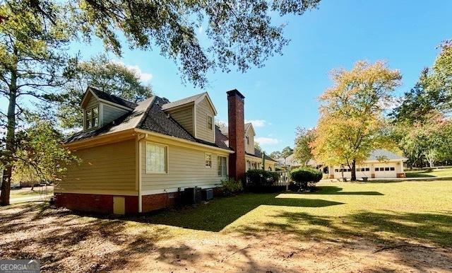 view of home's exterior with a yard