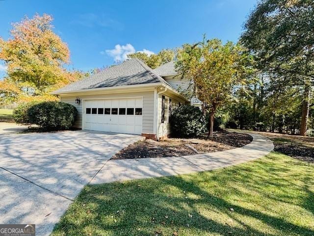 view of property exterior with driveway, a garage, a lawn, and roof with shingles