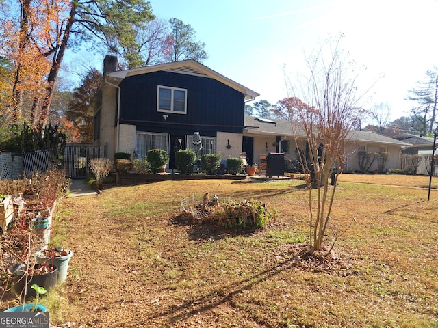 rear view of property featuring a yard