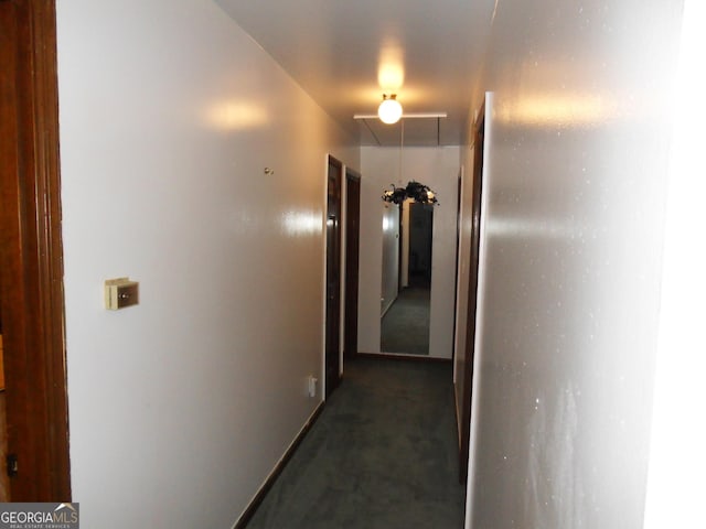 hall featuring dark carpet