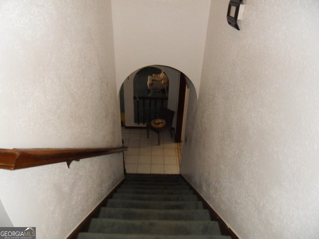 stairway featuring tile patterned flooring