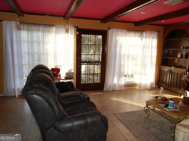 tiled living room featuring beamed ceiling