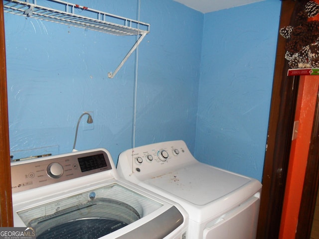 clothes washing area with washing machine and clothes dryer