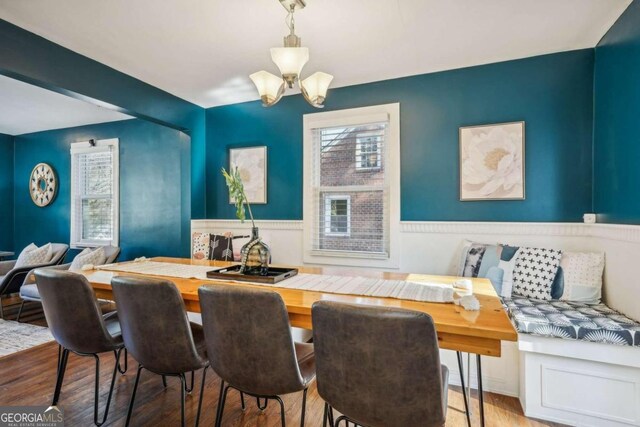 dining space featuring a chandelier and wood-type flooring