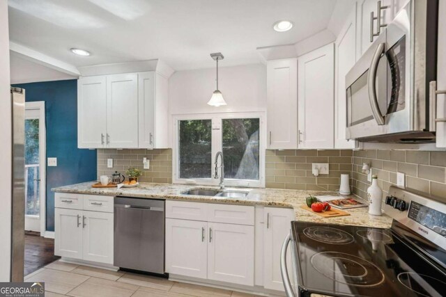 kitchen featuring white cabinetry, sink, and appliances with stainless steel finishes