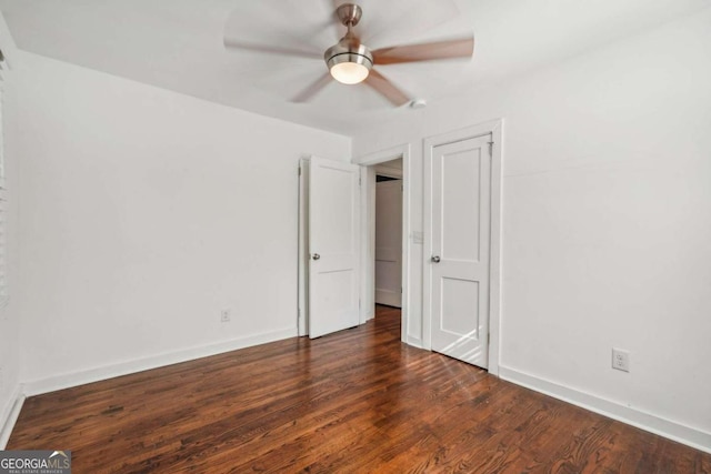 unfurnished bedroom featuring dark hardwood / wood-style floors and ceiling fan