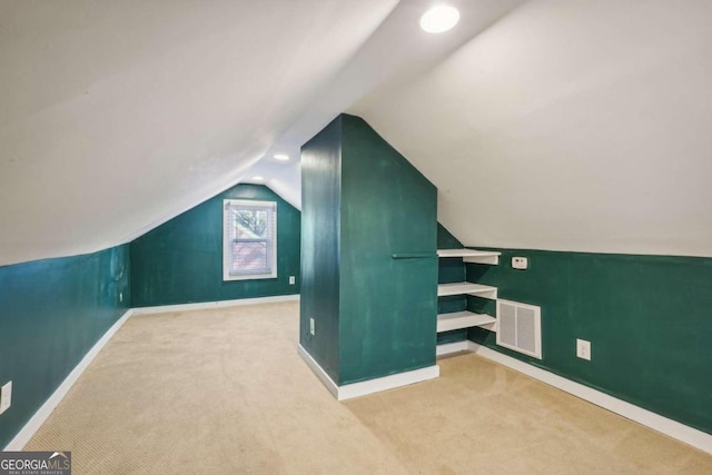 additional living space with light colored carpet and lofted ceiling