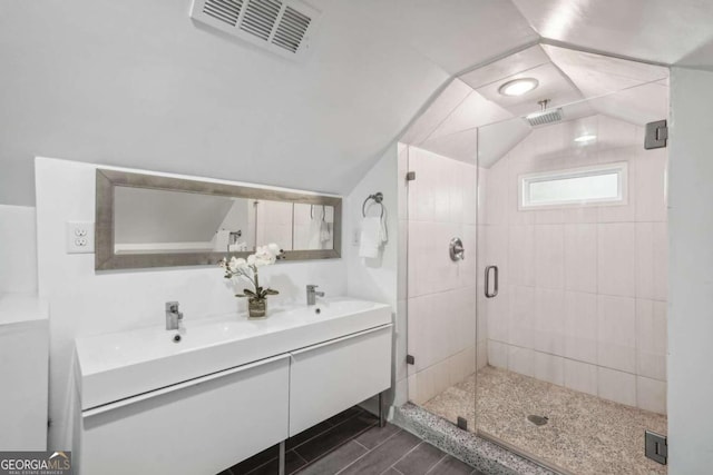 bathroom with hardwood / wood-style flooring, vanity, an enclosed shower, and lofted ceiling