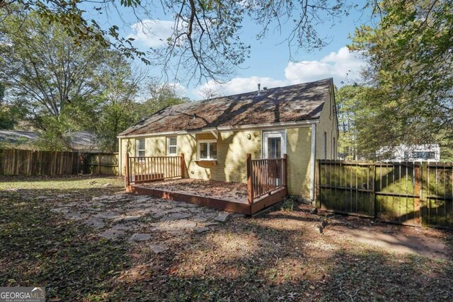 back of house with a wooden deck