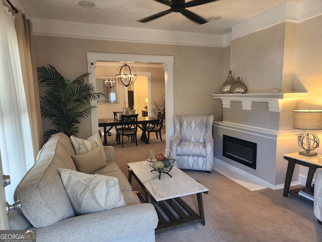 carpeted living room featuring a textured ceiling and ceiling fan with notable chandelier