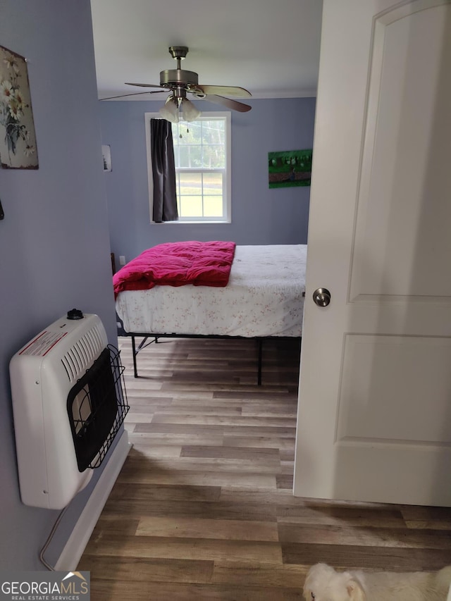 bedroom with ceiling fan and wood-type flooring