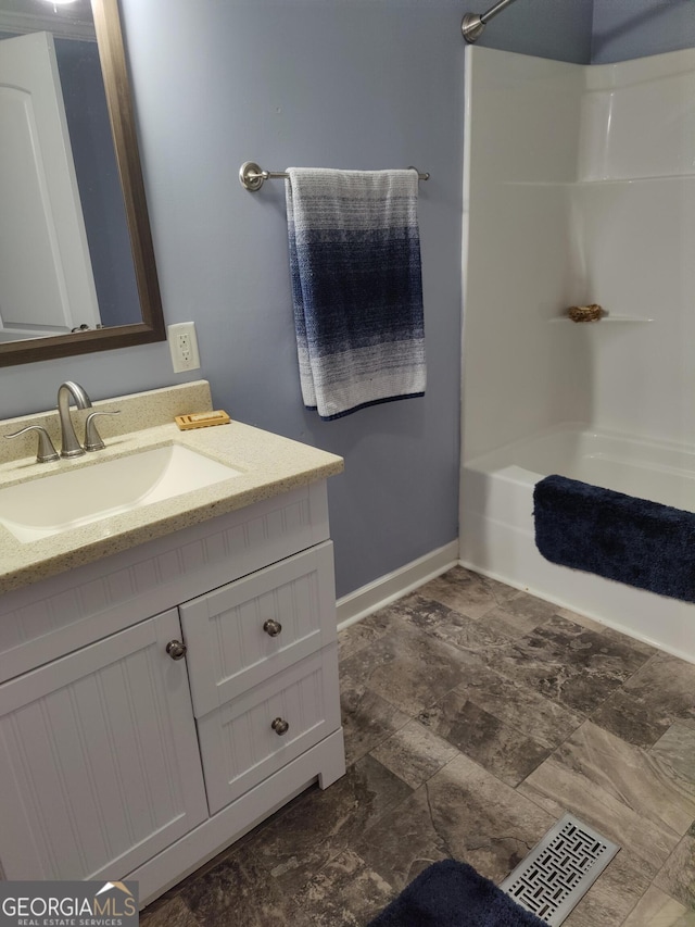 bathroom featuring vanity and  shower combination